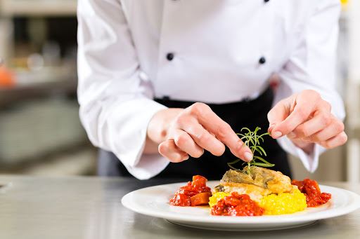 Chef garnishing a plate