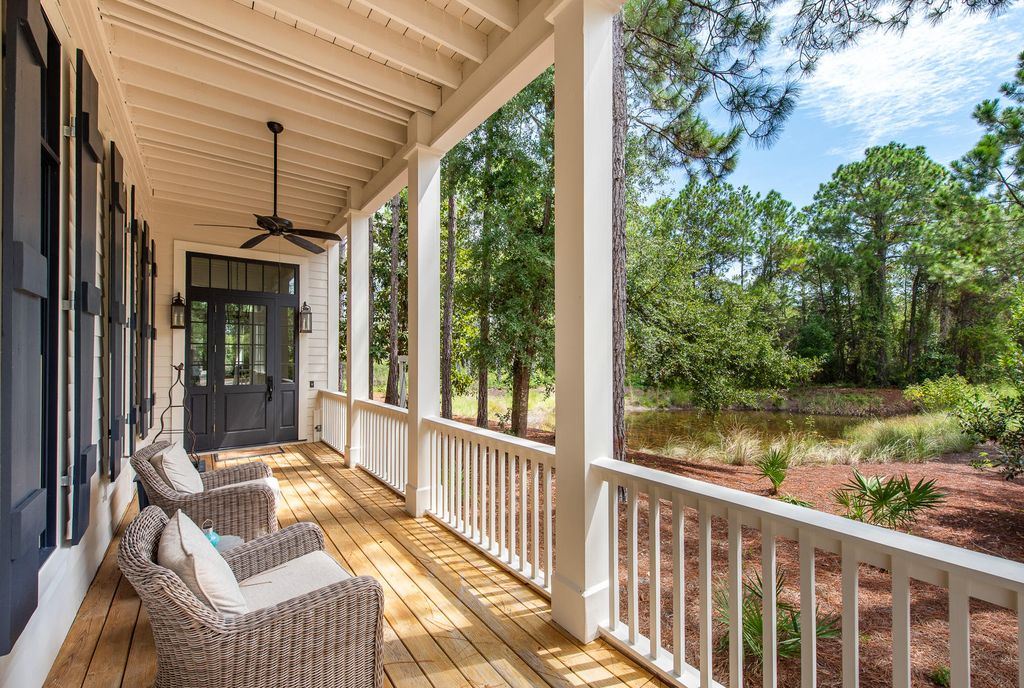 Porch with seating area with a view of lake beside them