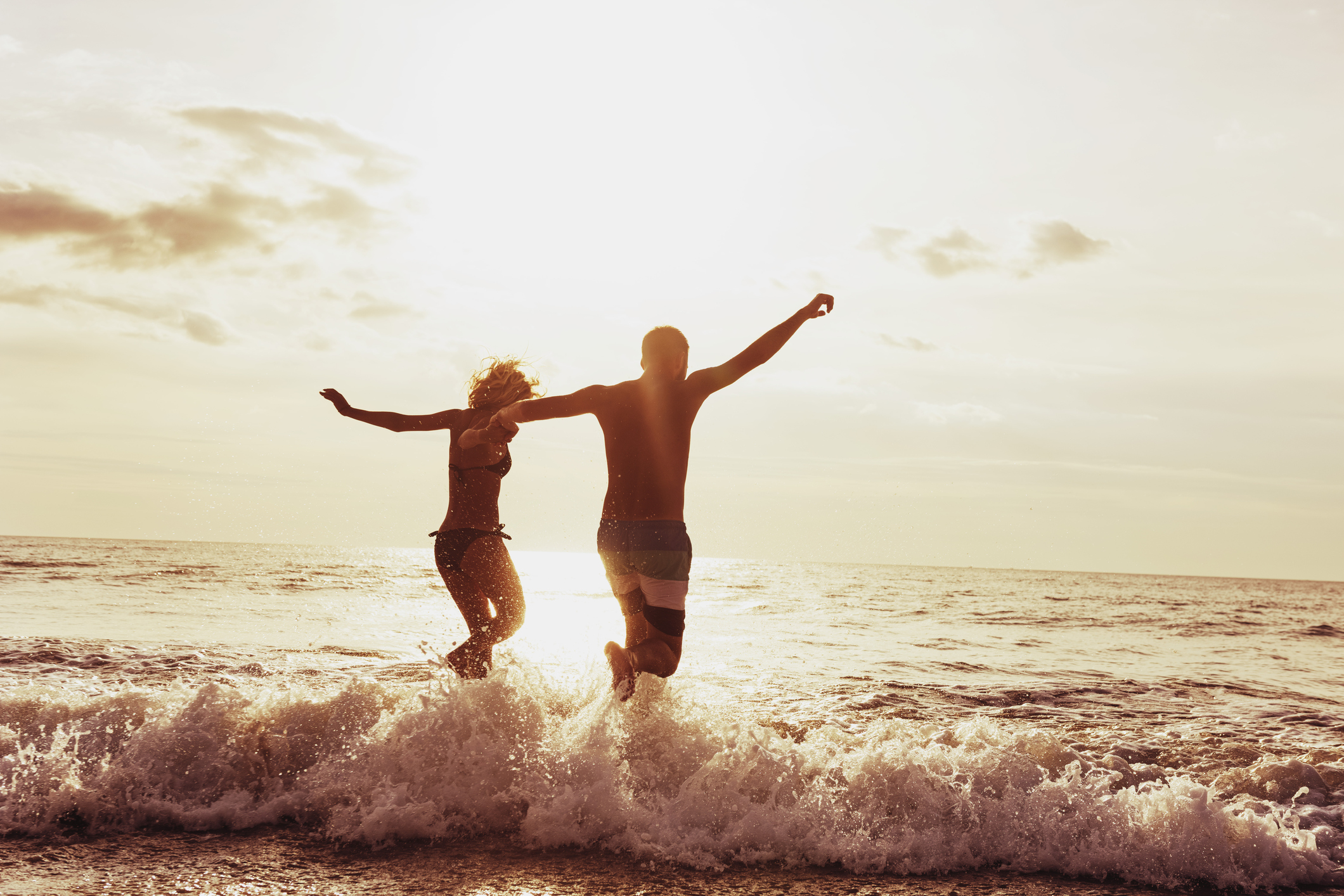 Happy couple sunset beach run