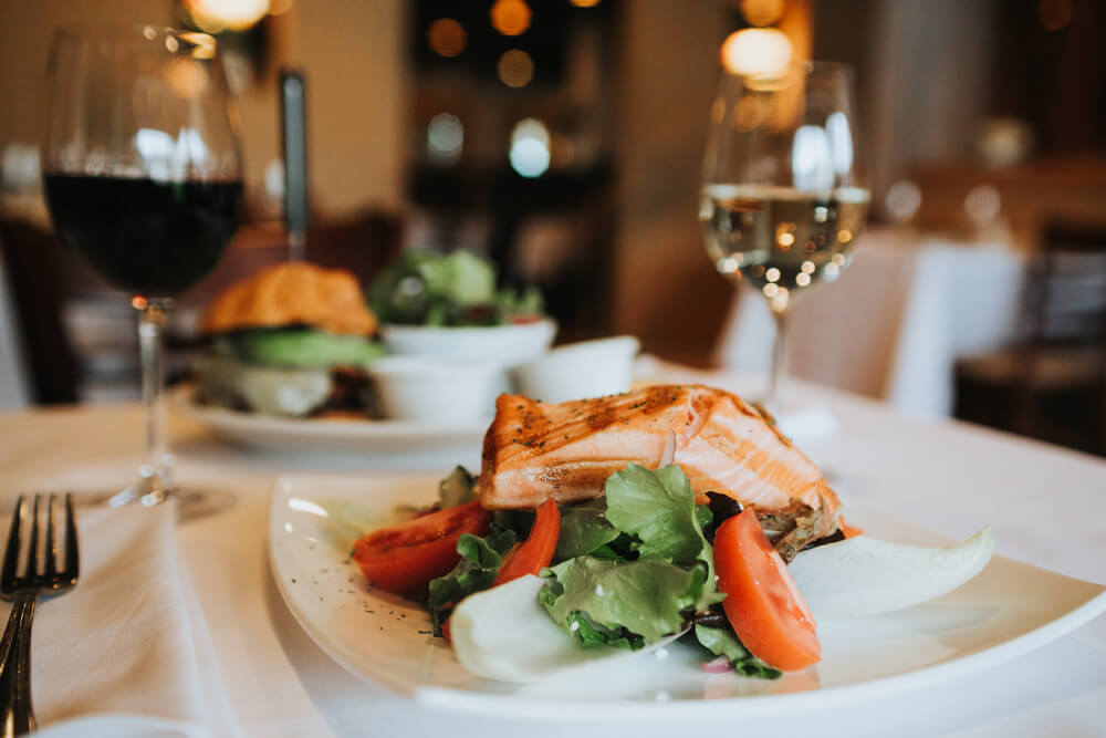 View of fish and wine glasses at one of the best restaurants on 30A